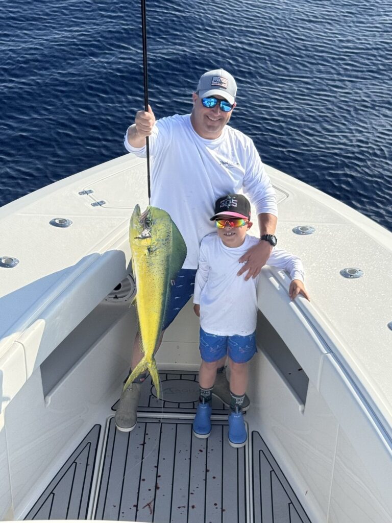 Father with young angler and his dolphin.