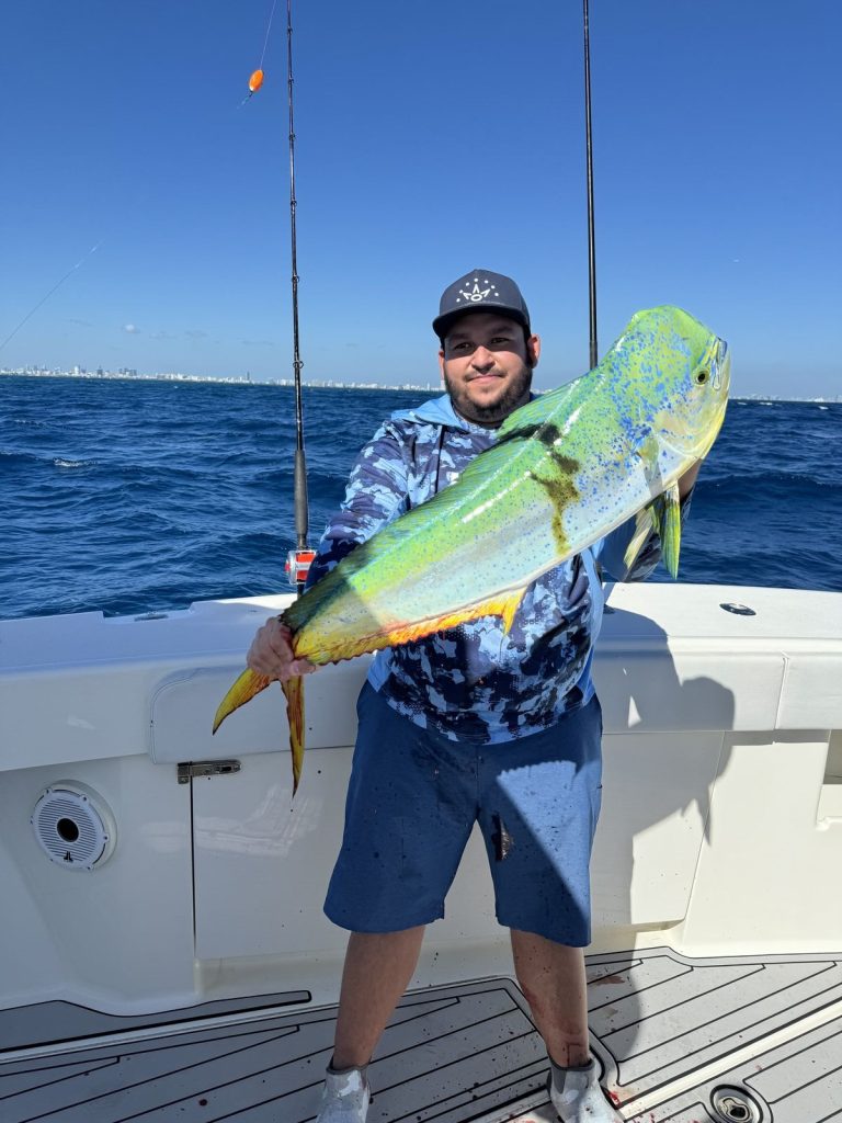 Angler with a colorful mahi-mahi caught off Miami