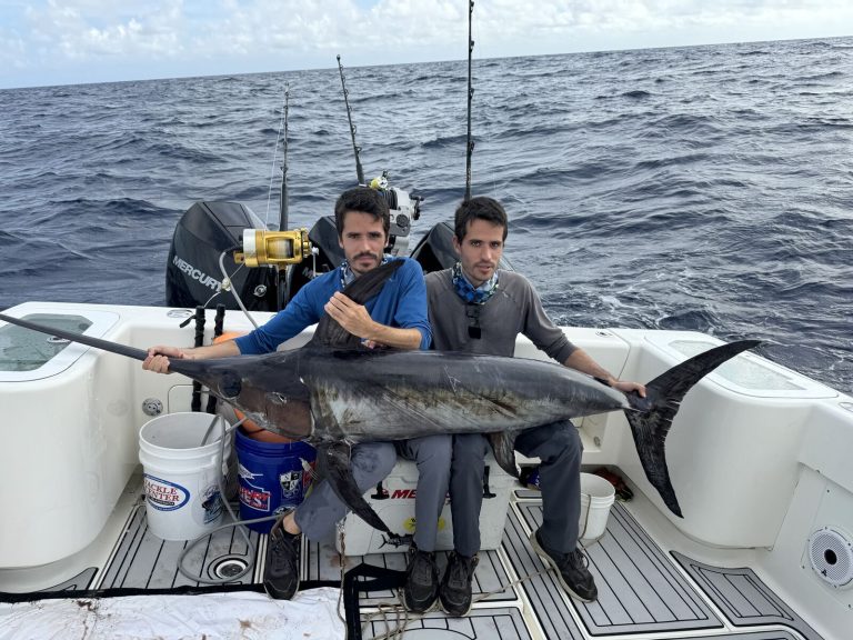 Two brothers posing with a swordfish caught off Miami