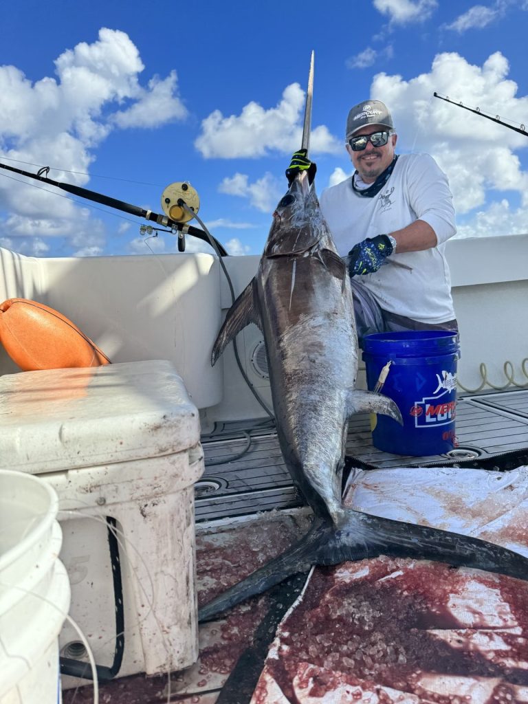 Captain Dean Panos with a swordfish caught while deep dropping