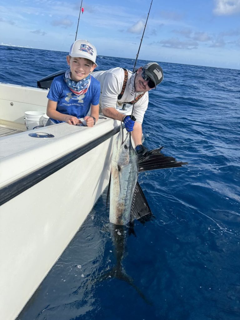 Young angler about to release a sailfish