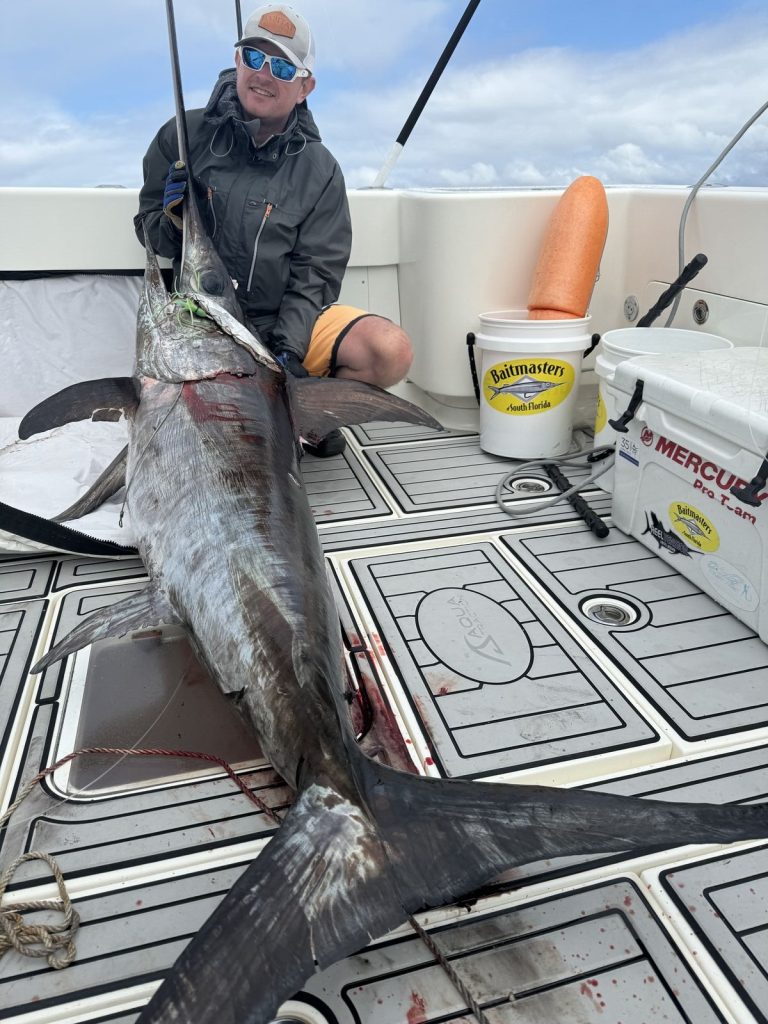 Angler with another swordfish caught on the Double D
