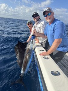 Happy anglers about to release a sailfish